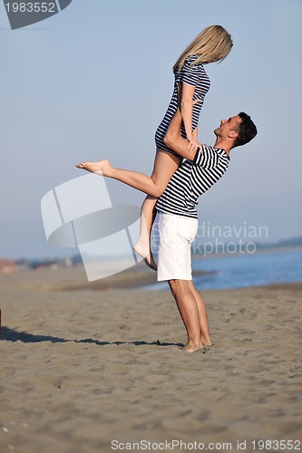 Image of happy young couple have fun on beach