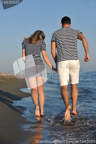 Image of happy young couple have romantic time on beach