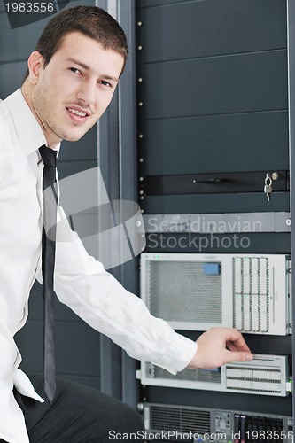 Image of young it engeneer in datacenter server room