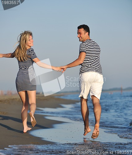 Image of happy young couple have romantic time on beach