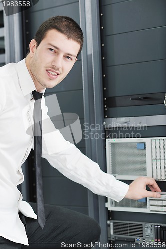 Image of young it engeneer in datacenter server room