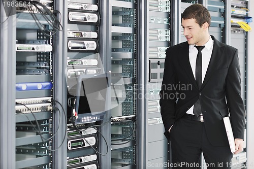 Image of young it engeneer in datacenter server room