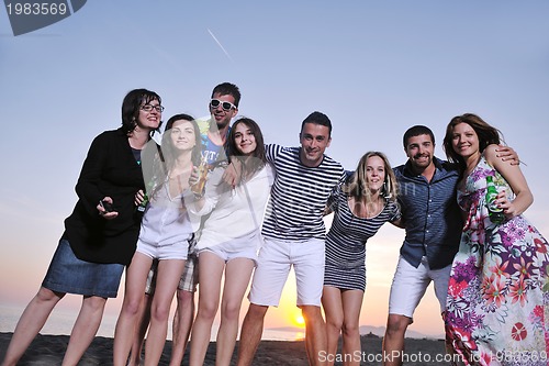 Image of Group of young people enjoy summer  party at the beach