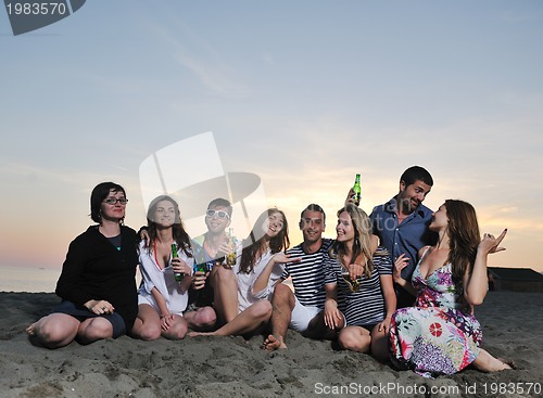 Image of Group of young people enjoy summer  party at the beach