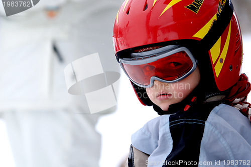 Image of Little skier with helmet and goggles