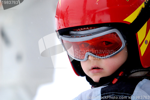 Image of Little skier with helmet and goggles