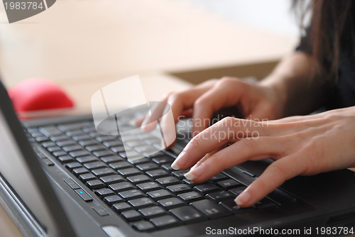 Image of woman hands typing on laptop keyboard