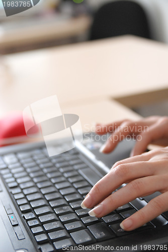 Image of woman hands typing on laptop keyboard