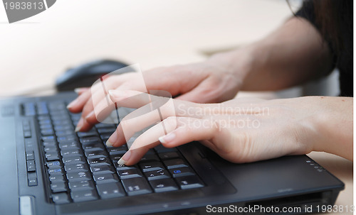 Image of woman hands typing on laptop keyboard