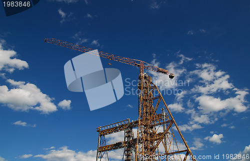 Image of crane with dramatic clouds  in background