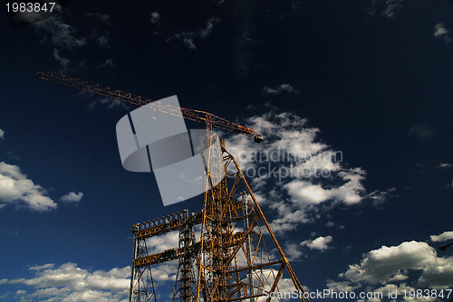 Image of crane with dramatic clouds  in background