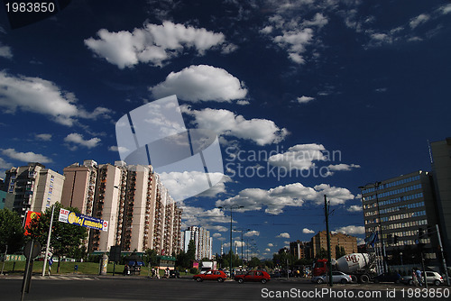 Image of traffic in the city and blue sky with dramatic clouds