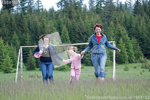 Image of happy girls running in nature