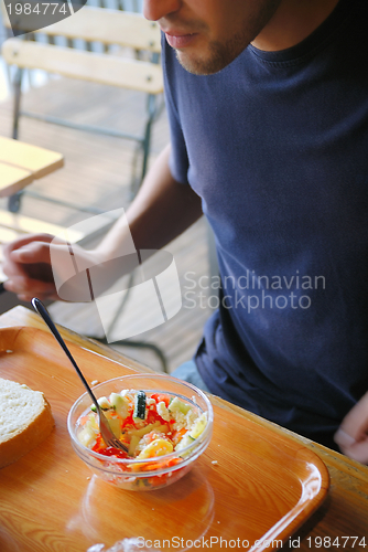 Image of man eating healthy food it an restaurant