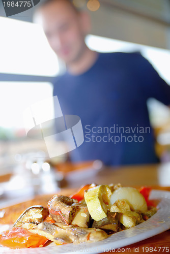 Image of man eating healthy food it an restaurant