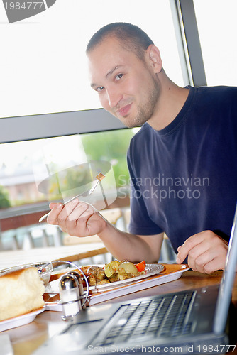 Image of man eating healthy food it an restaurant