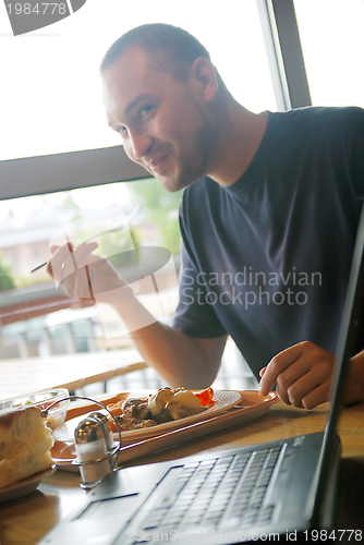 Image of man eating healthy food it an restaurant