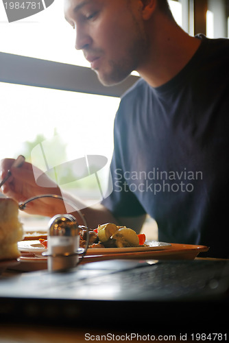 Image of man eating healthy food it an restaurant