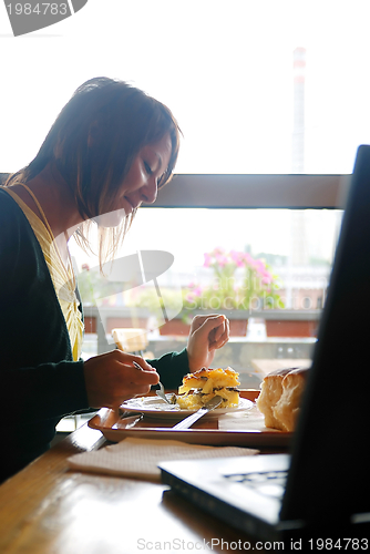 Image of woman eating at an restaurant