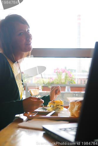 Image of woman eating at an restaurant