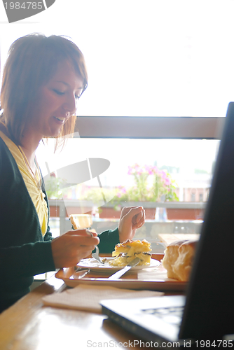 Image of woman eating at an restaurant
