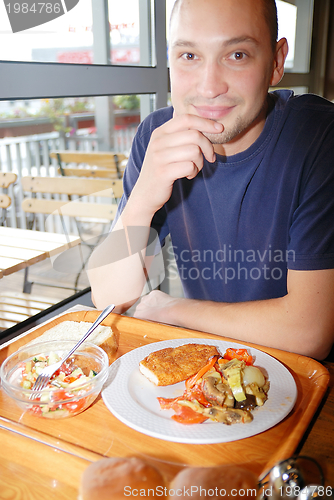 Image of man eating healthy food it an restaurant