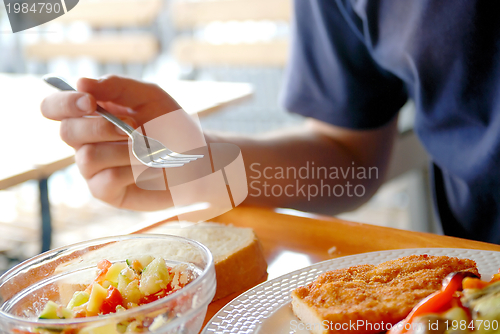 Image of man eating healthy food it an restaurant