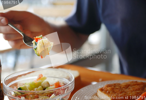 Image of man eating healthy food it an restaurant