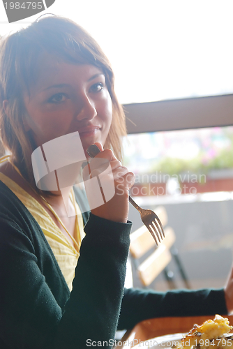 Image of woman eating at an restaurant