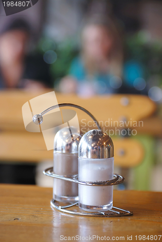 Image of salt and paper shaker in restaurant