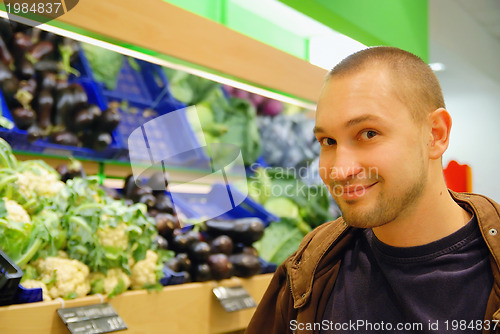 Image of smiling man in supermarket