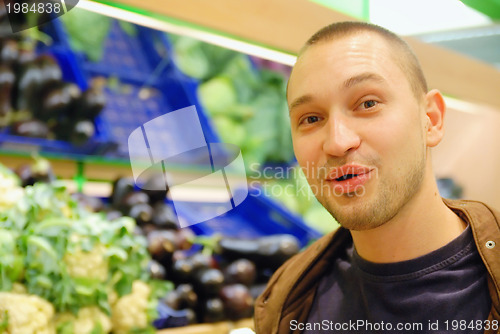 Image of smiling man in supermarket