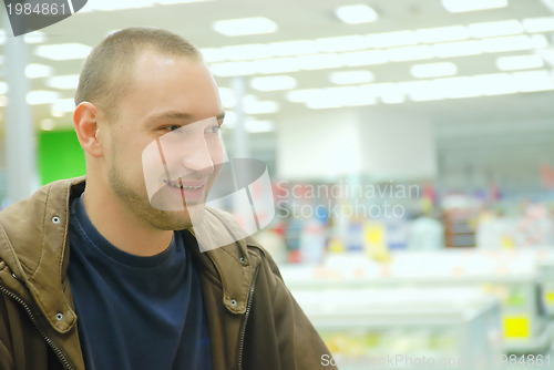 Image of smiling man in supermarket