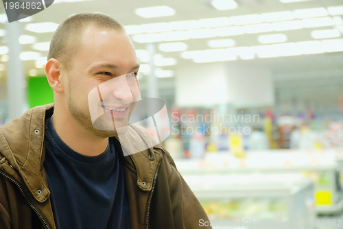 Image of smiling man in supermarket