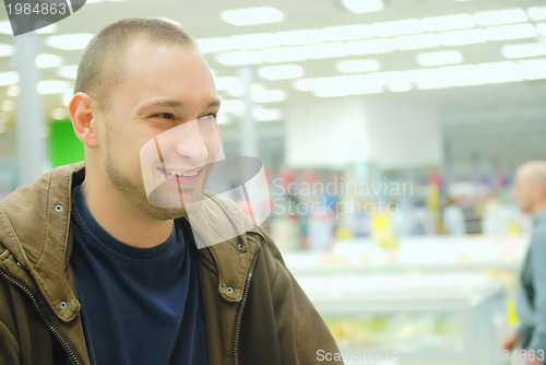 Image of smiling man in supermarket