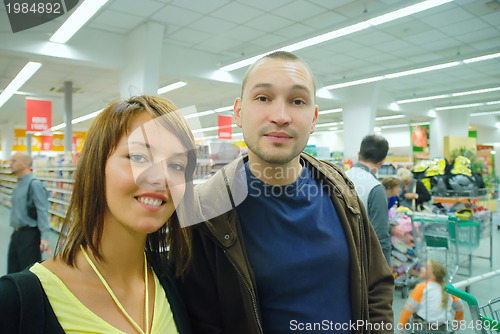 Image of happy young couple in supermarket