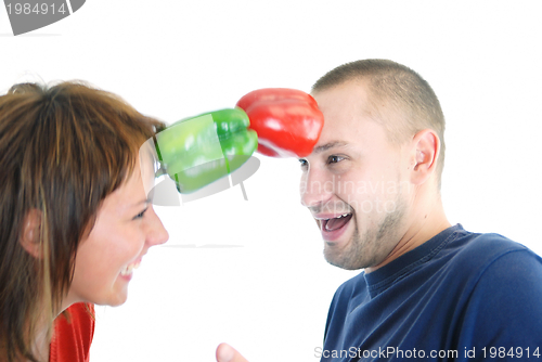 Image of happy couple holding peppers with head