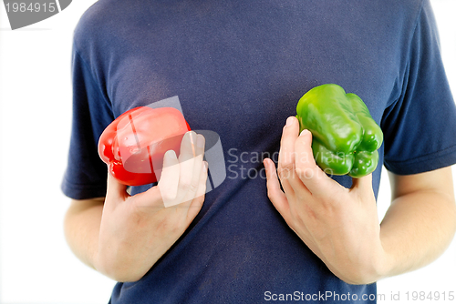 Image of happy couple holding peppers with head