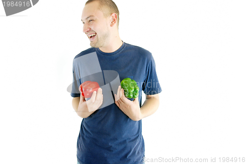 Image of happy couple holding peppers with head