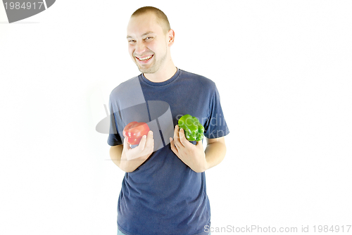 Image of happy couple holding peppers with head