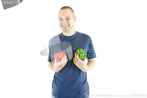 Image of happy couple holding peppers with head