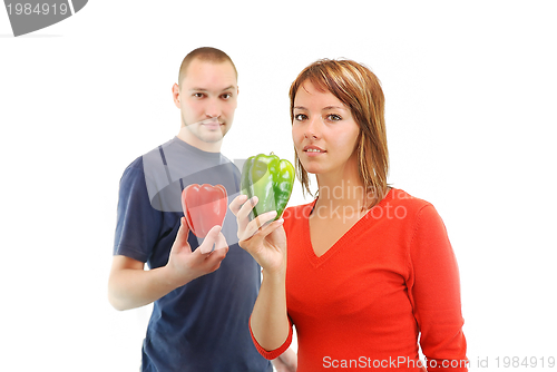 Image of happy couple with peppers isolated