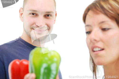 Image of happy couple with peppers isolated