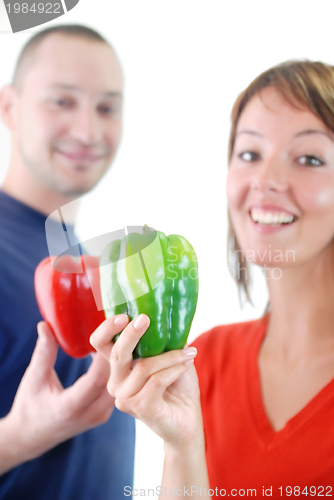 Image of happy couple with peppers isolated