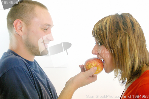 Image of healthy couple with apple