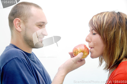 Image of healthy couple with apple