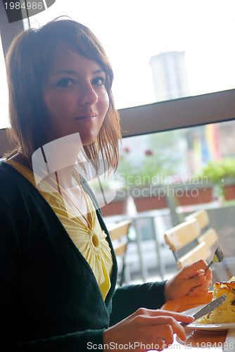 Image of woman eating at an restaurant