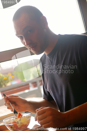 Image of man eating healthy food it an restaurant