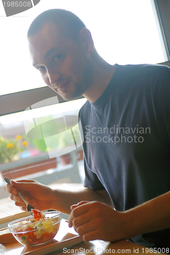 Image of man eating healthy food it an restaurant