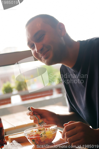 Image of man eating healthy food it an restaurant